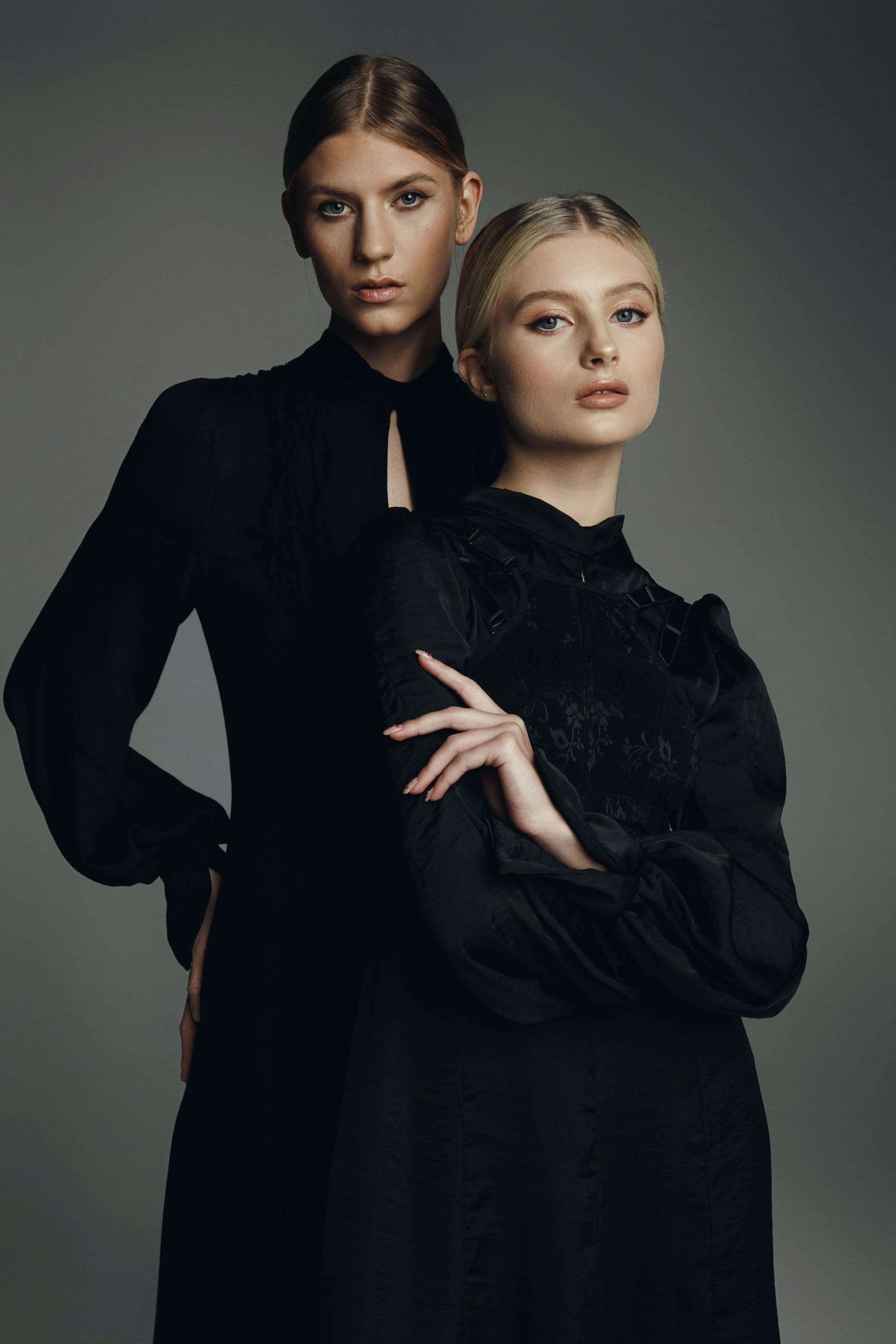 Dwie kobiety w eleganckich czarnych sukienkach